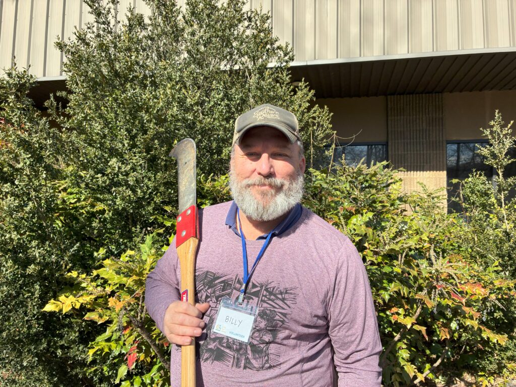 Tooligan Billy holding a pole saw
