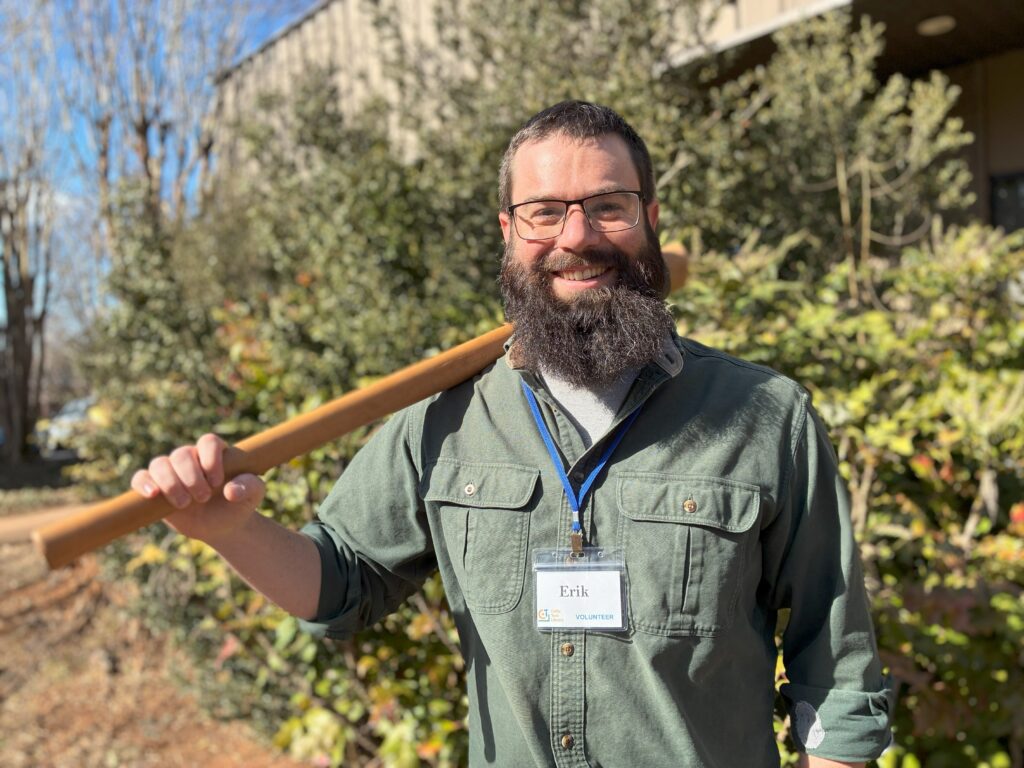 Tooligan Erik holding a long-handled tool