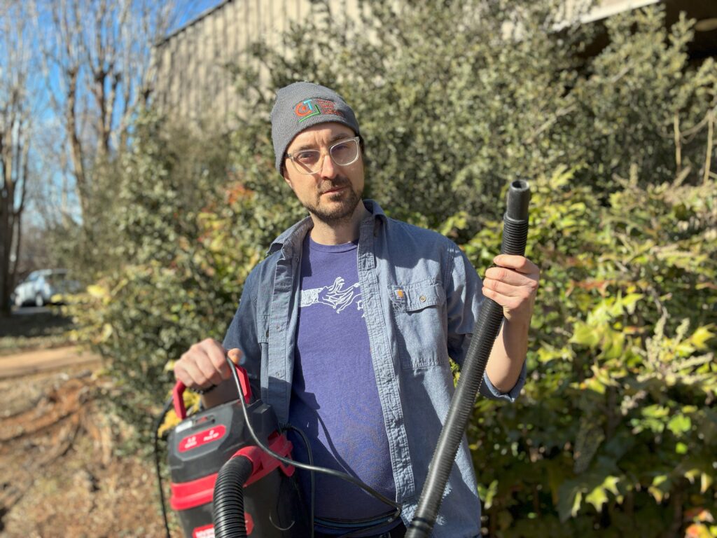 Tooligan Jason holding a shop vacuum