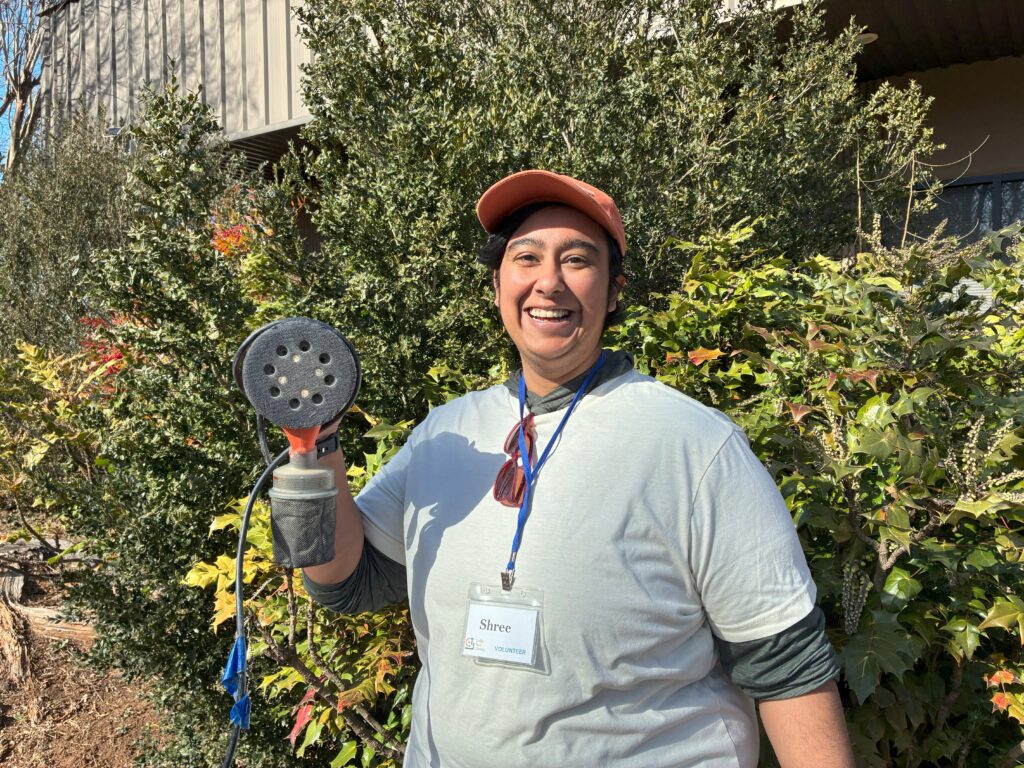 Librarian Shree holding an orbital sander